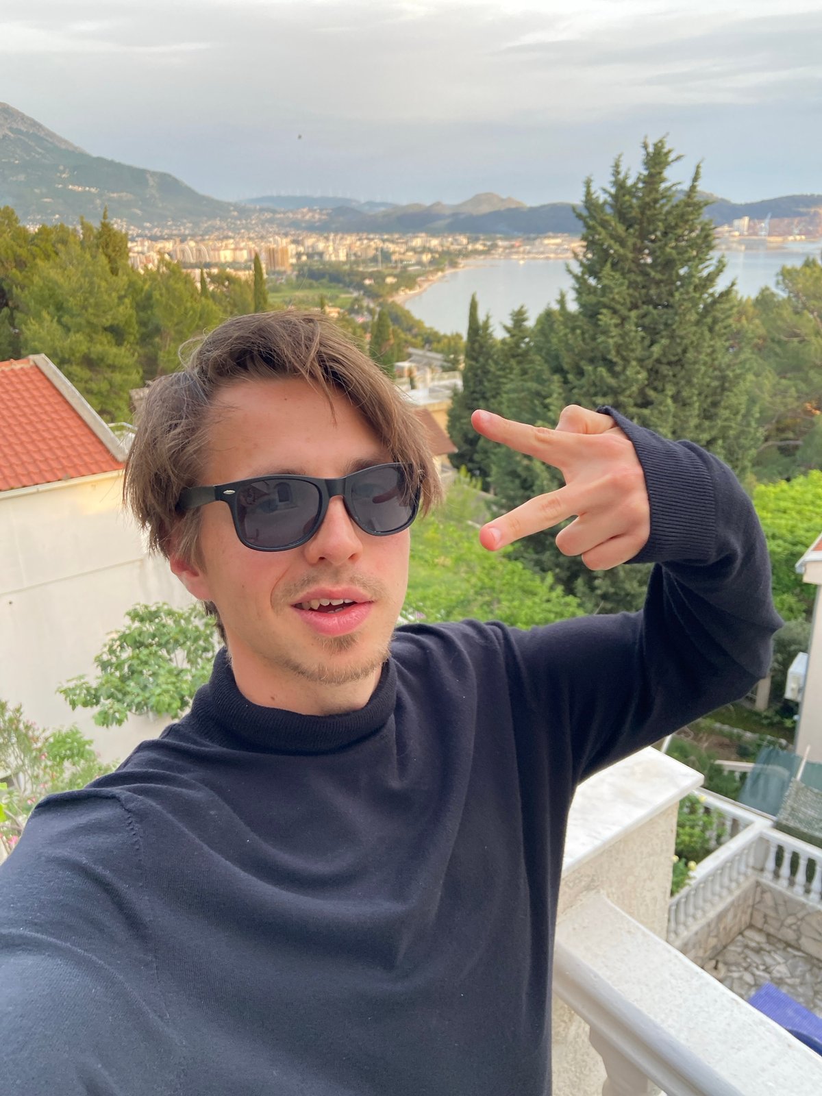 Tourist takes selfies on scenic overlook in Šušanj, Montenegro