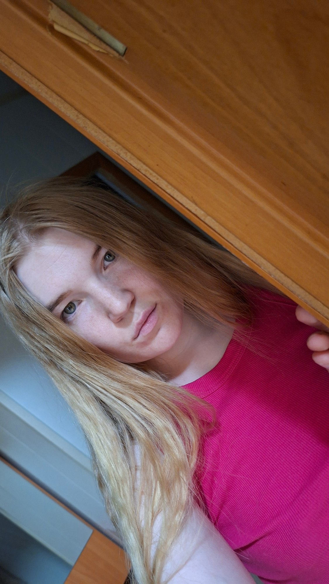 Young woman takes playful selfies indoors in rural Russia