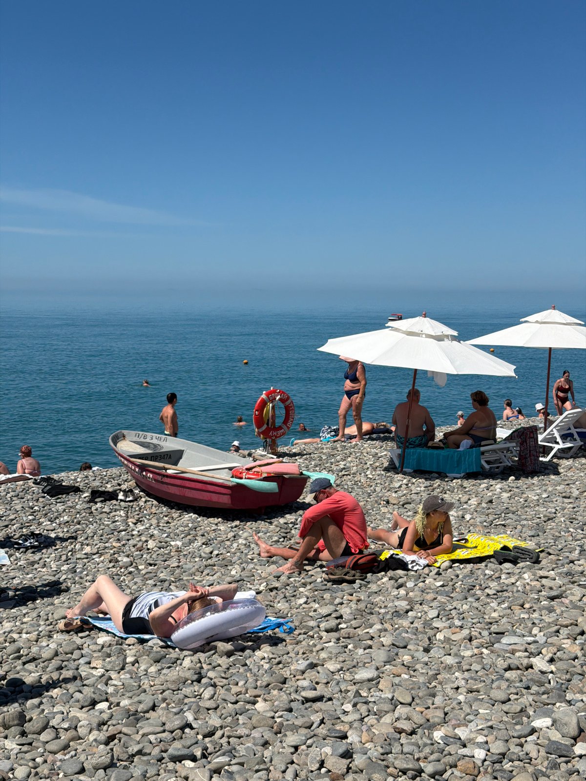 Crowded Black Sea beach in Sochi on a clear summer morning