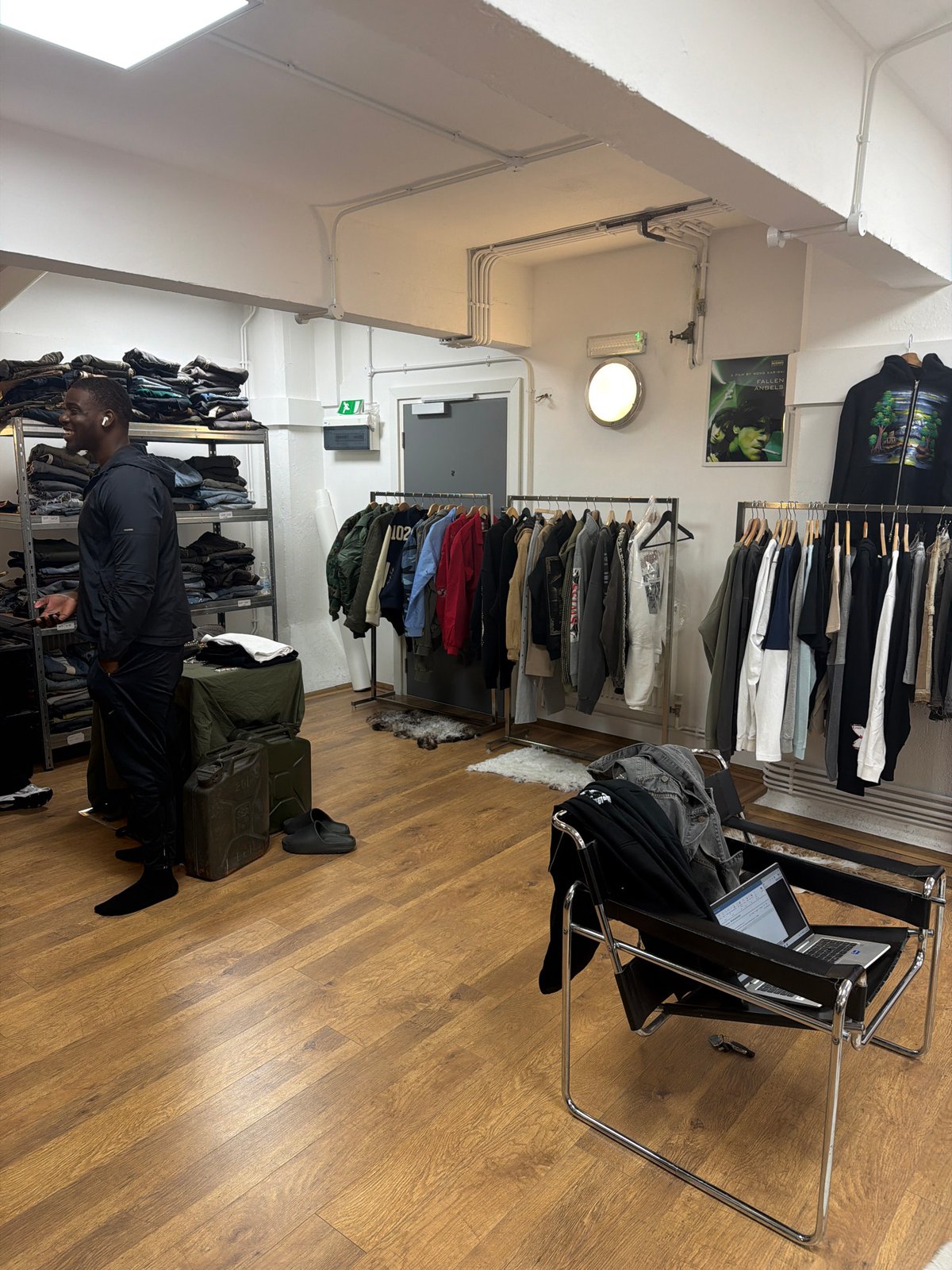 Two men browse London clothing store amid afternoon shopping