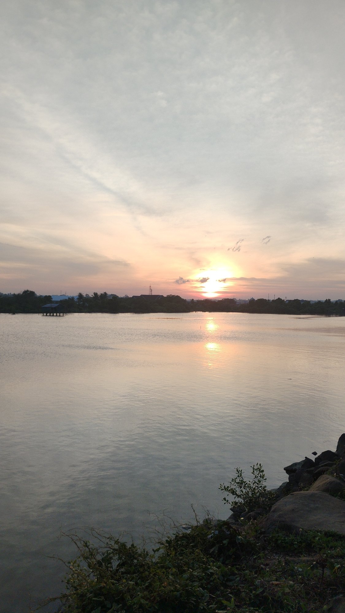 Sunset over calm coastal waters in Lhokseumawe, Indonesia