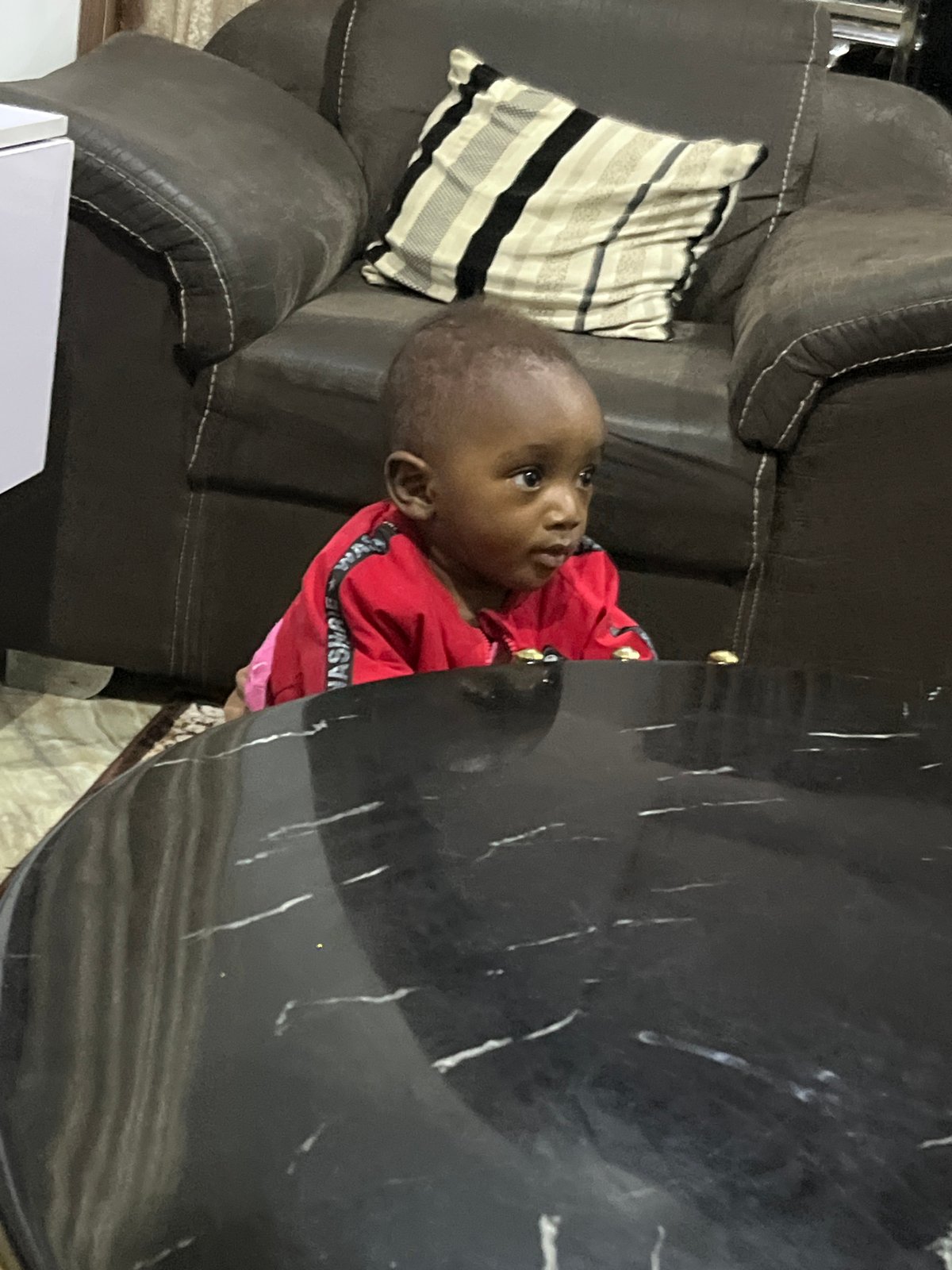 Afternoon at a Jos home: family indoors, cooking and resting