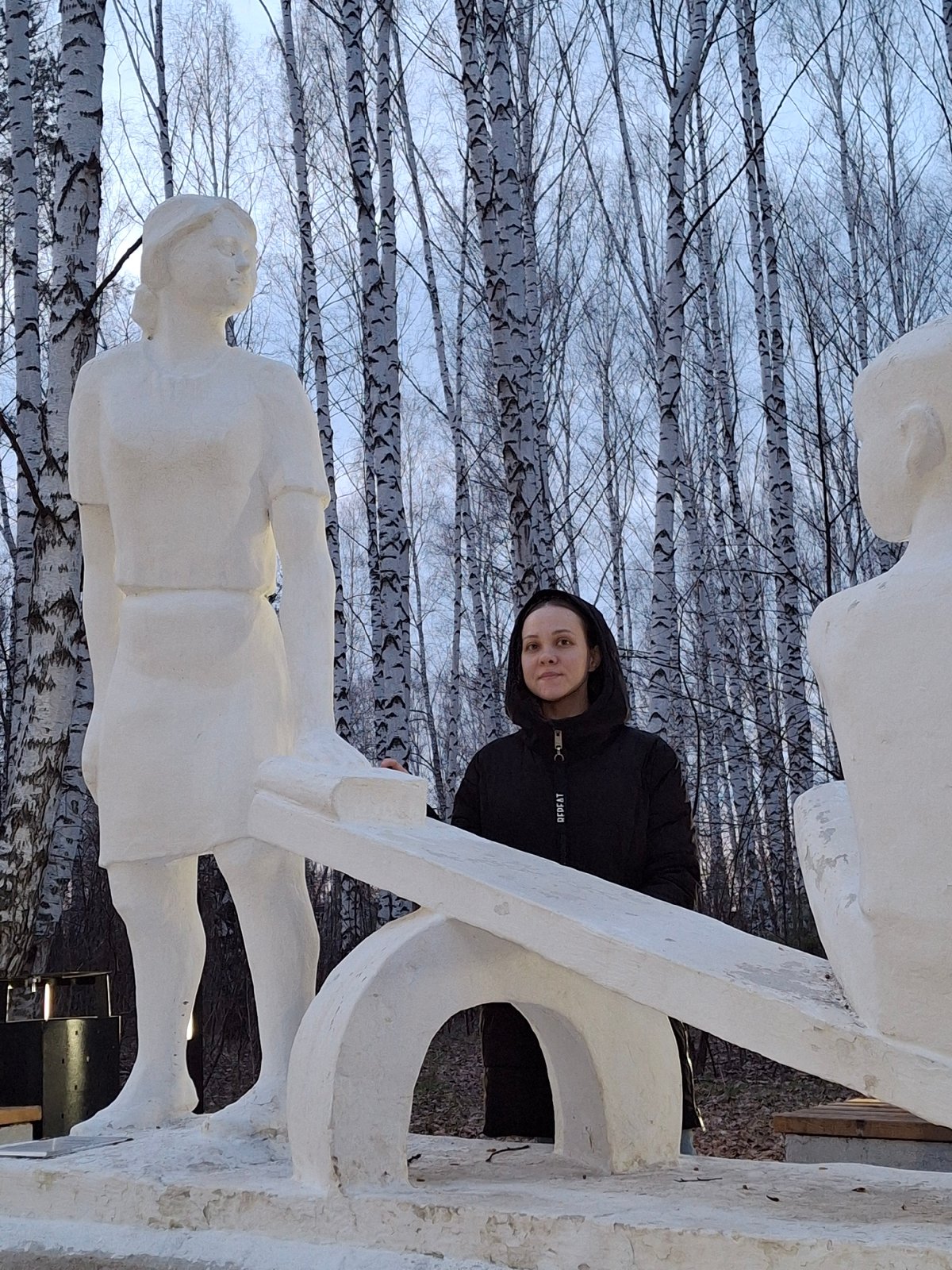 Woman photographed at sculpture installation in Chaikovsky, Russia