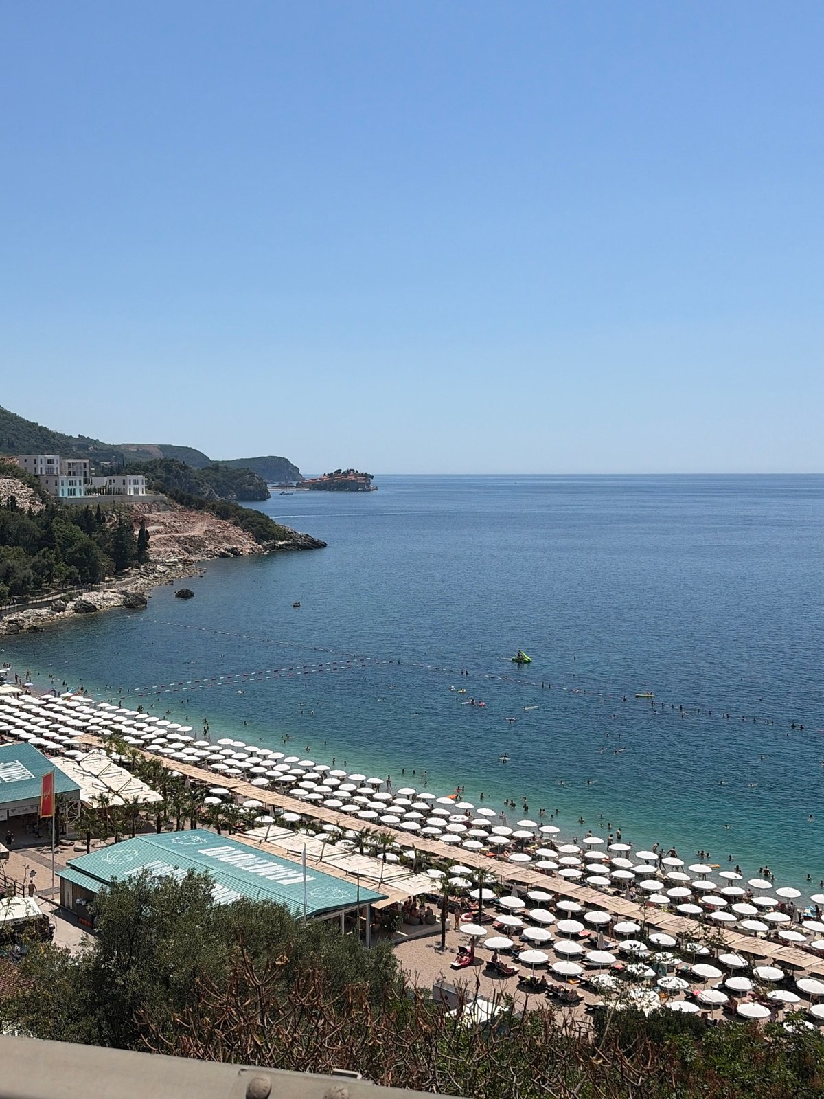 Busy summer morning at Kamenovo beach and Trap village, Montenegro