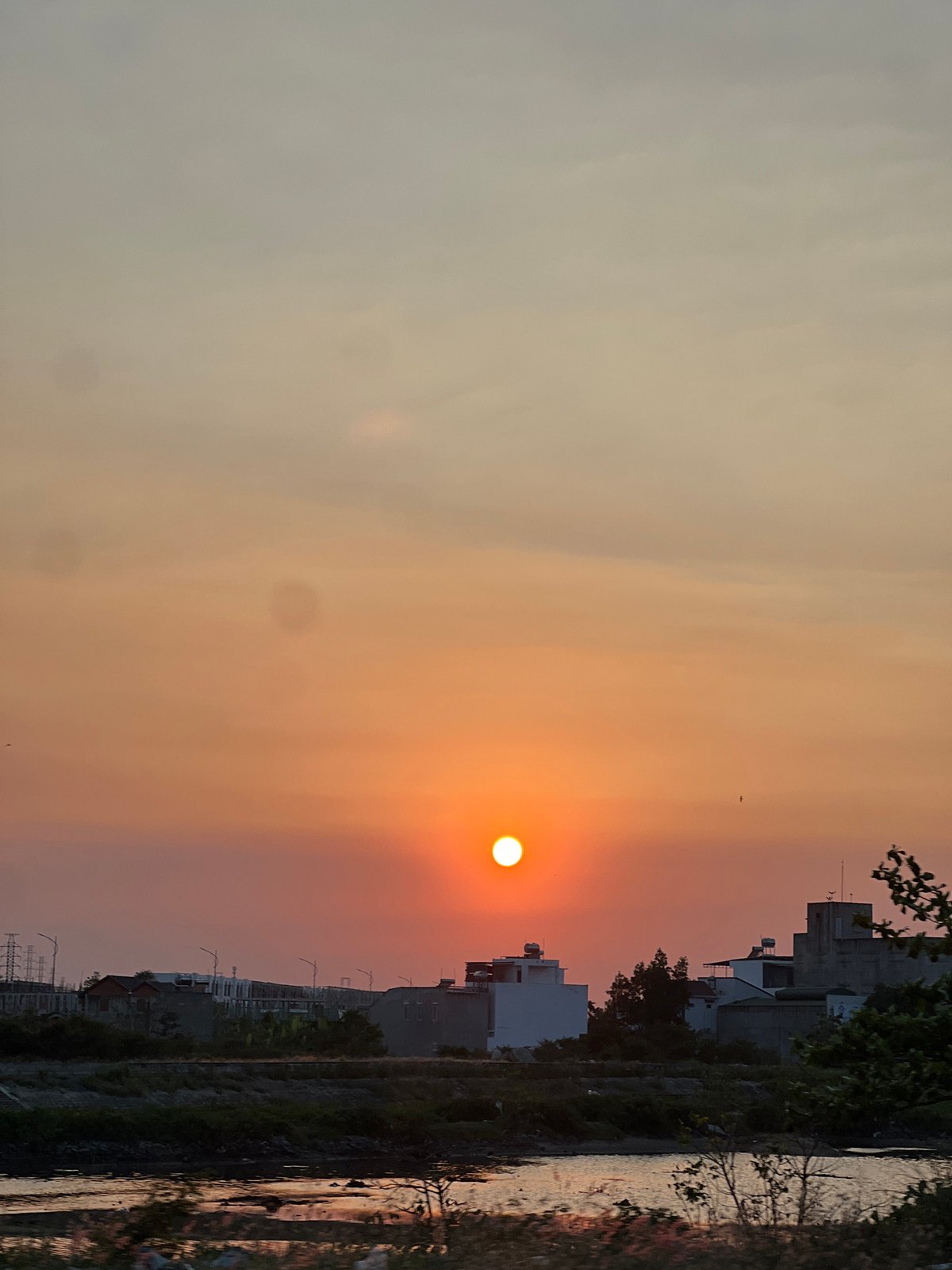Orange sunset captured over urban Nha Trang, Vietnam