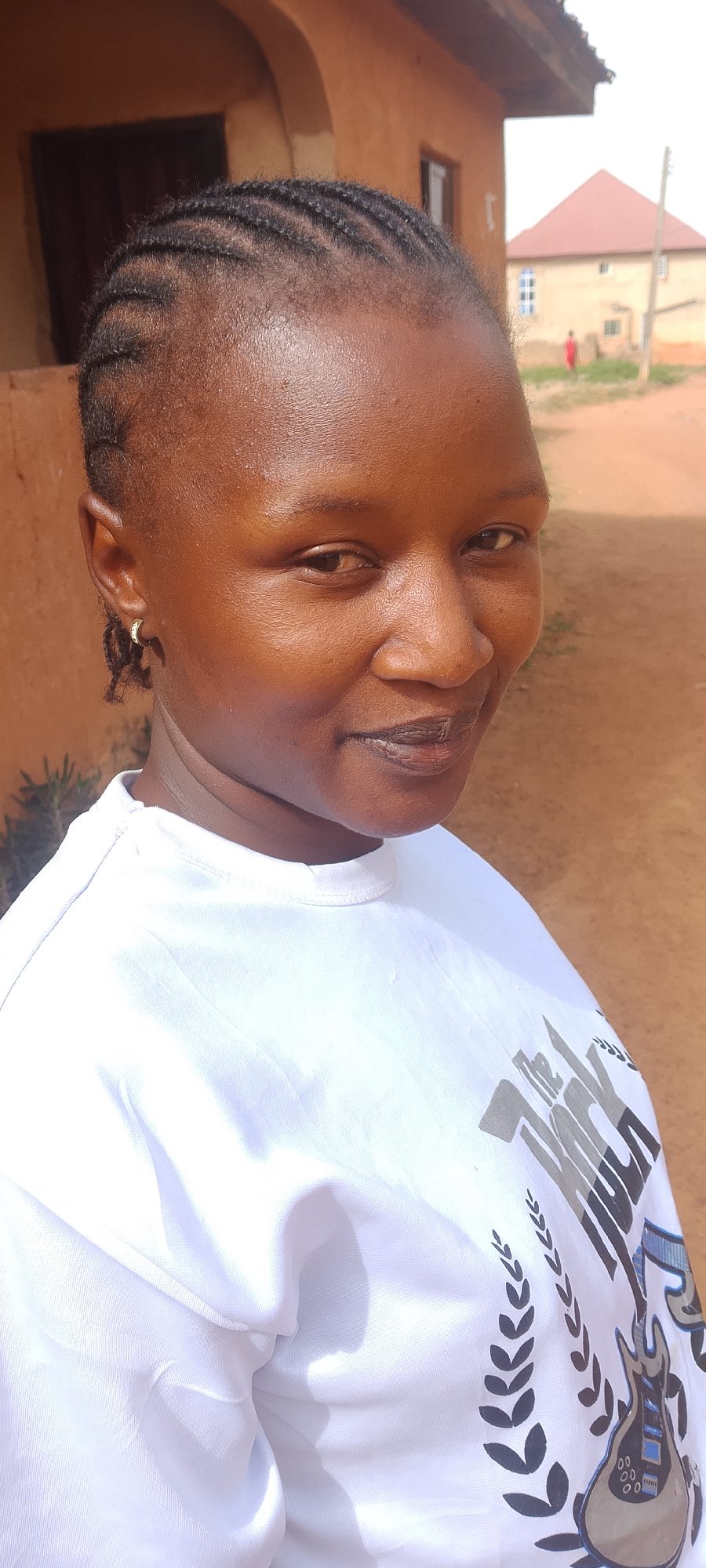 Woman in white graphic tee spotted across Jos, Nigeria