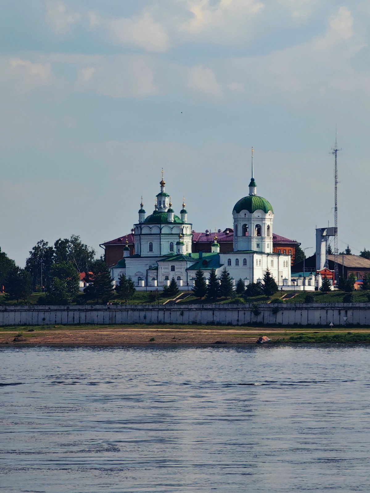 Yeniseysk riverfront and its historic church skyline from the water