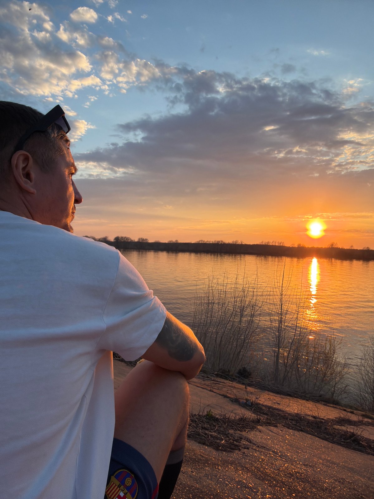 Person enjoys sunset moment by Kama River in Chaikovsky
