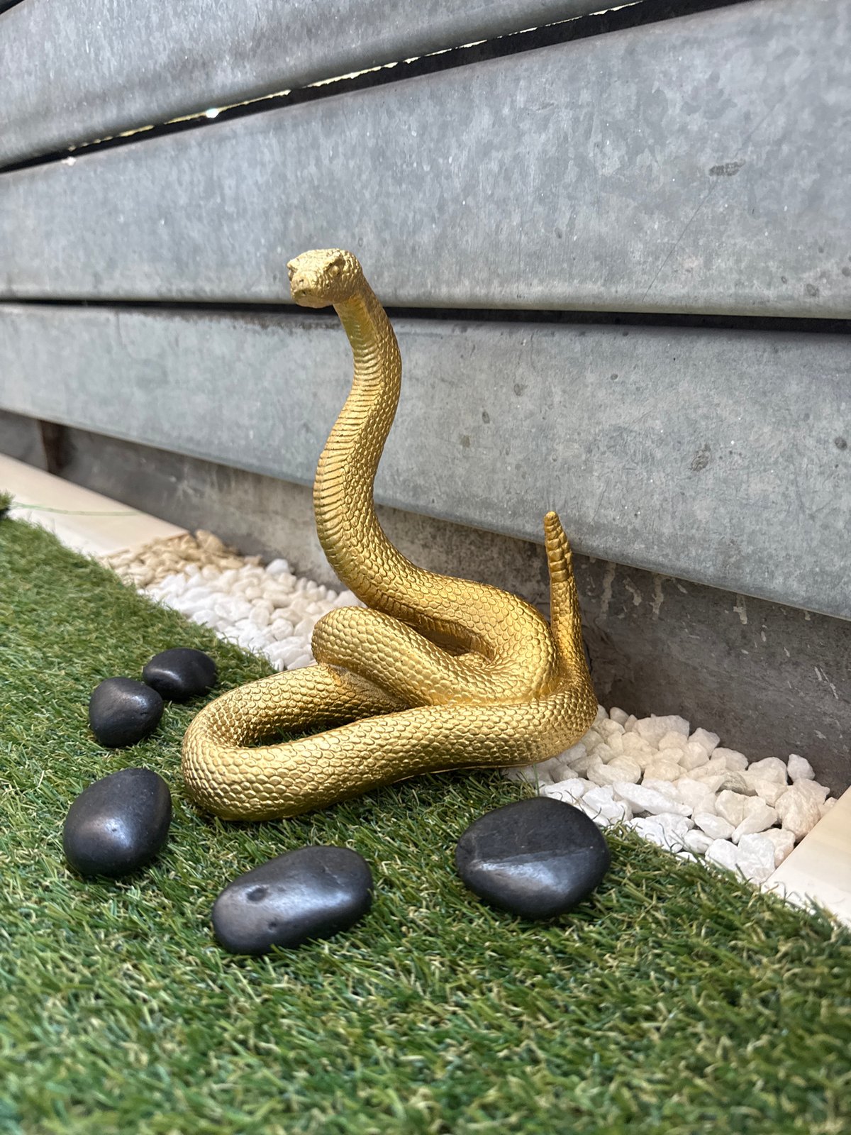 Ornamental garden display with figurines on artificial grass in Sofia