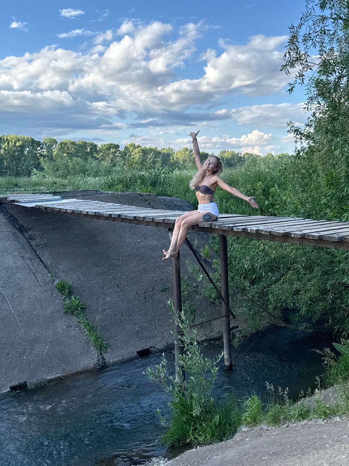 Woman photographs swing session near bridge in Chaikovsky Russia