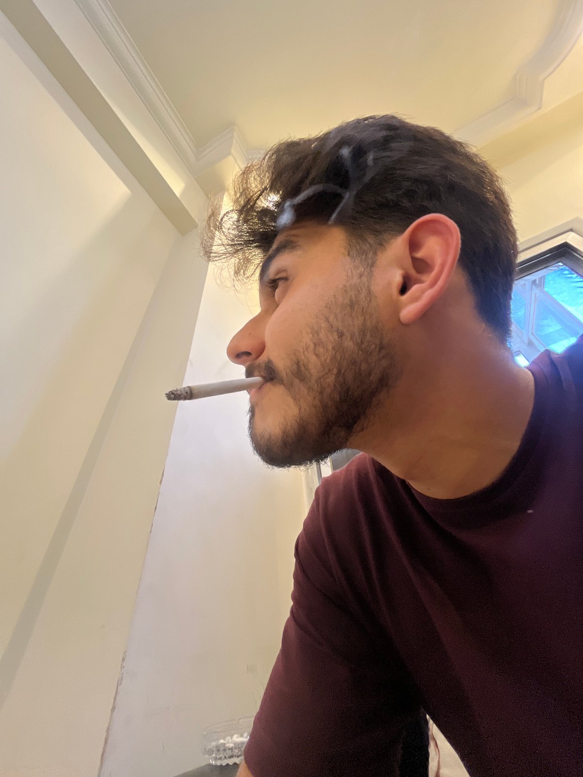 Man spends afternoon smoking and relaxing indoors in Damascus