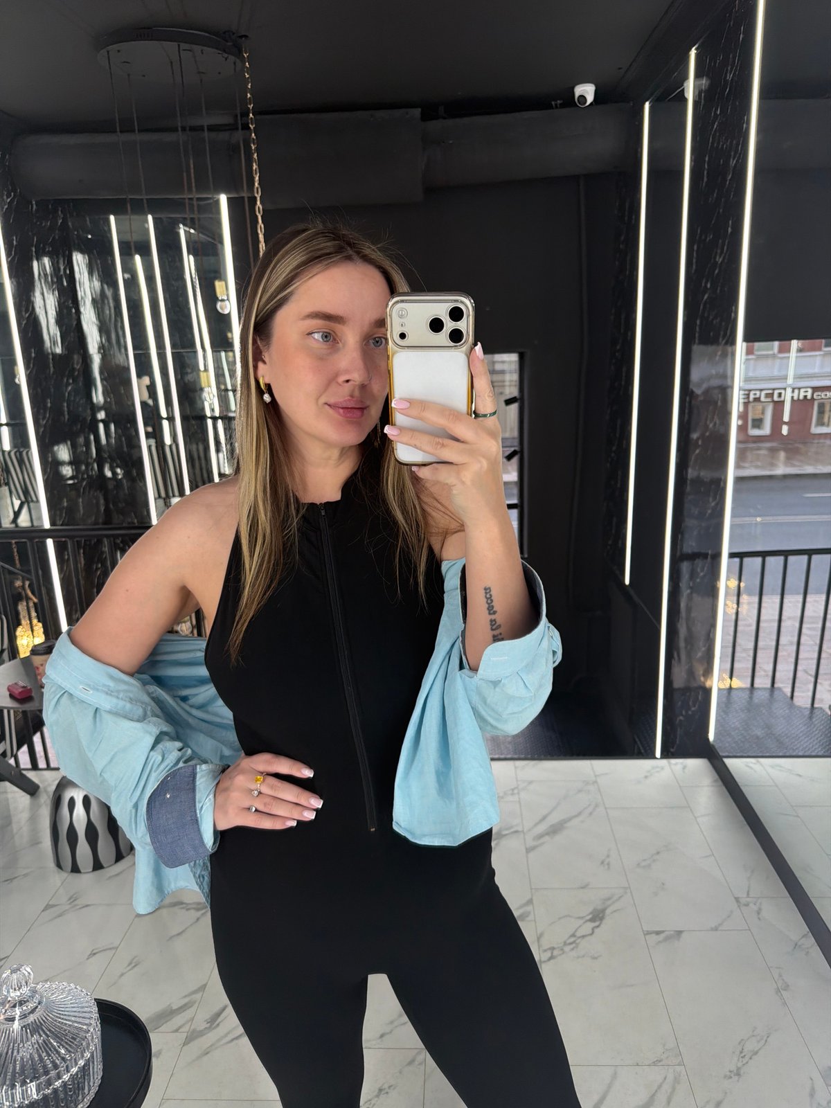 Woman photographed taking selfies in Moscow retail space