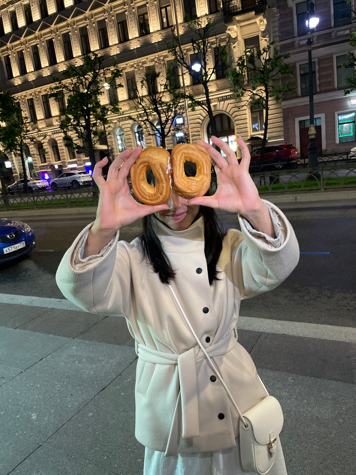 Couple enjoys pastries during evening stroll in Saint Petersburg