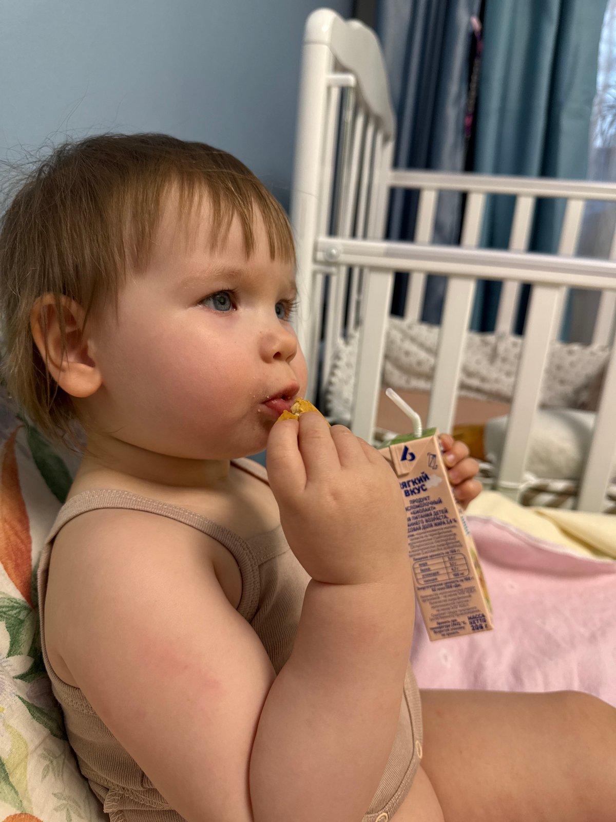 Toddler enjoys snack and juice in Moscow