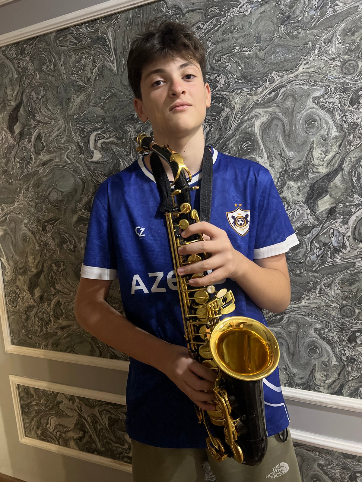 Saxophone and collectibles arranged in a Masazir interior