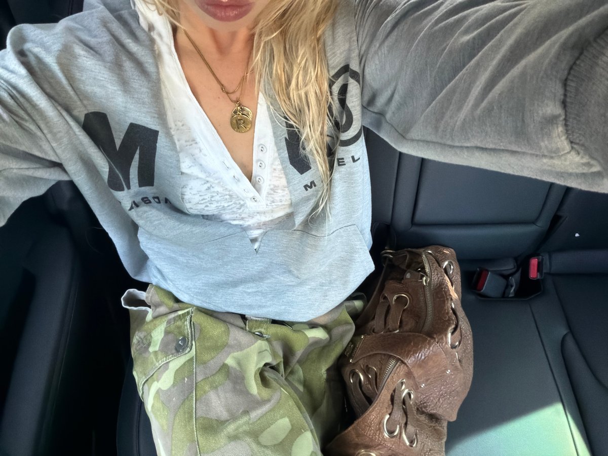 Person in grey sweatshirt observed in vehicle backseat, Seoul