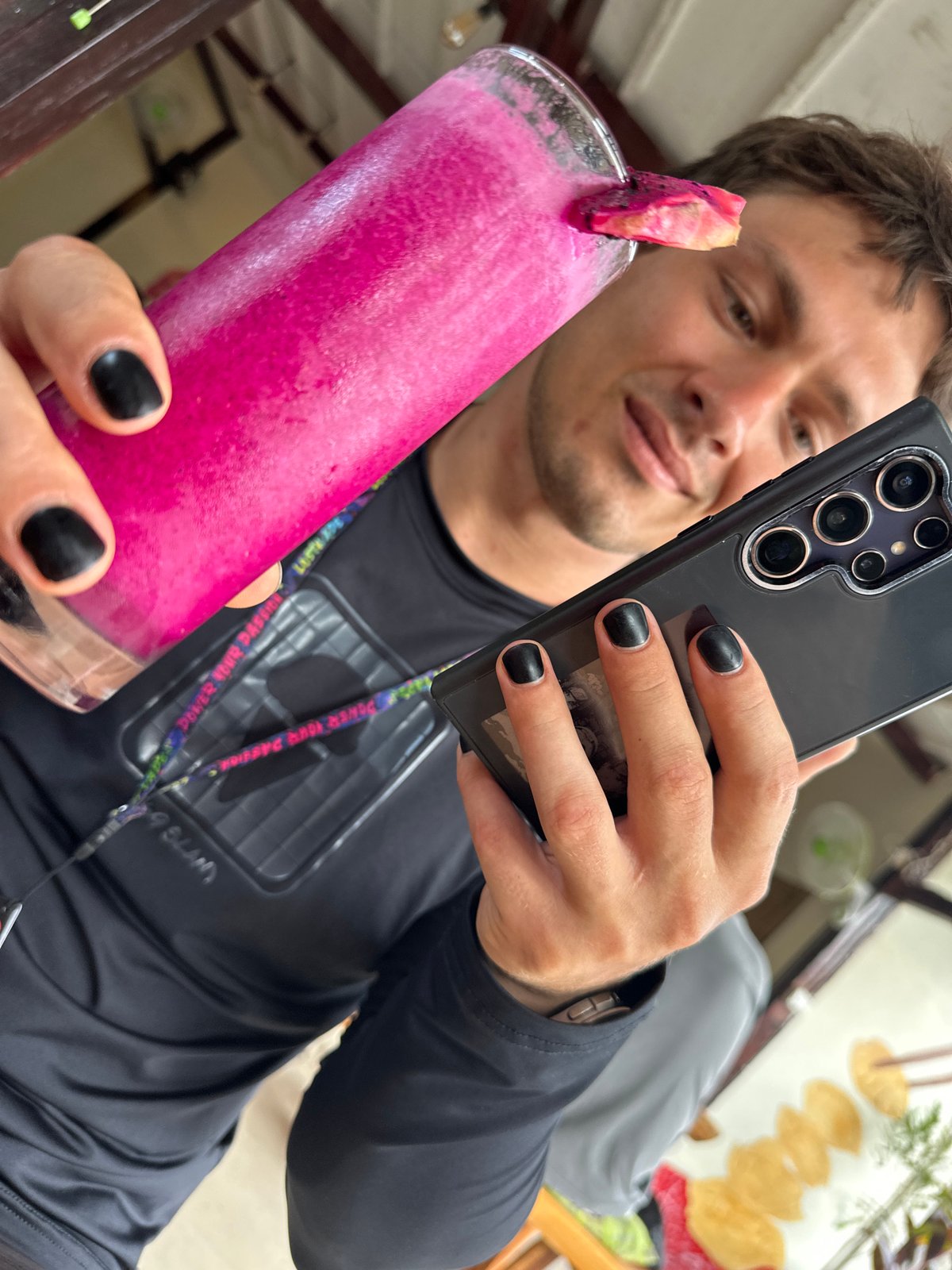 Person enjoys pink smoothie with dragon fruit in Indonesia