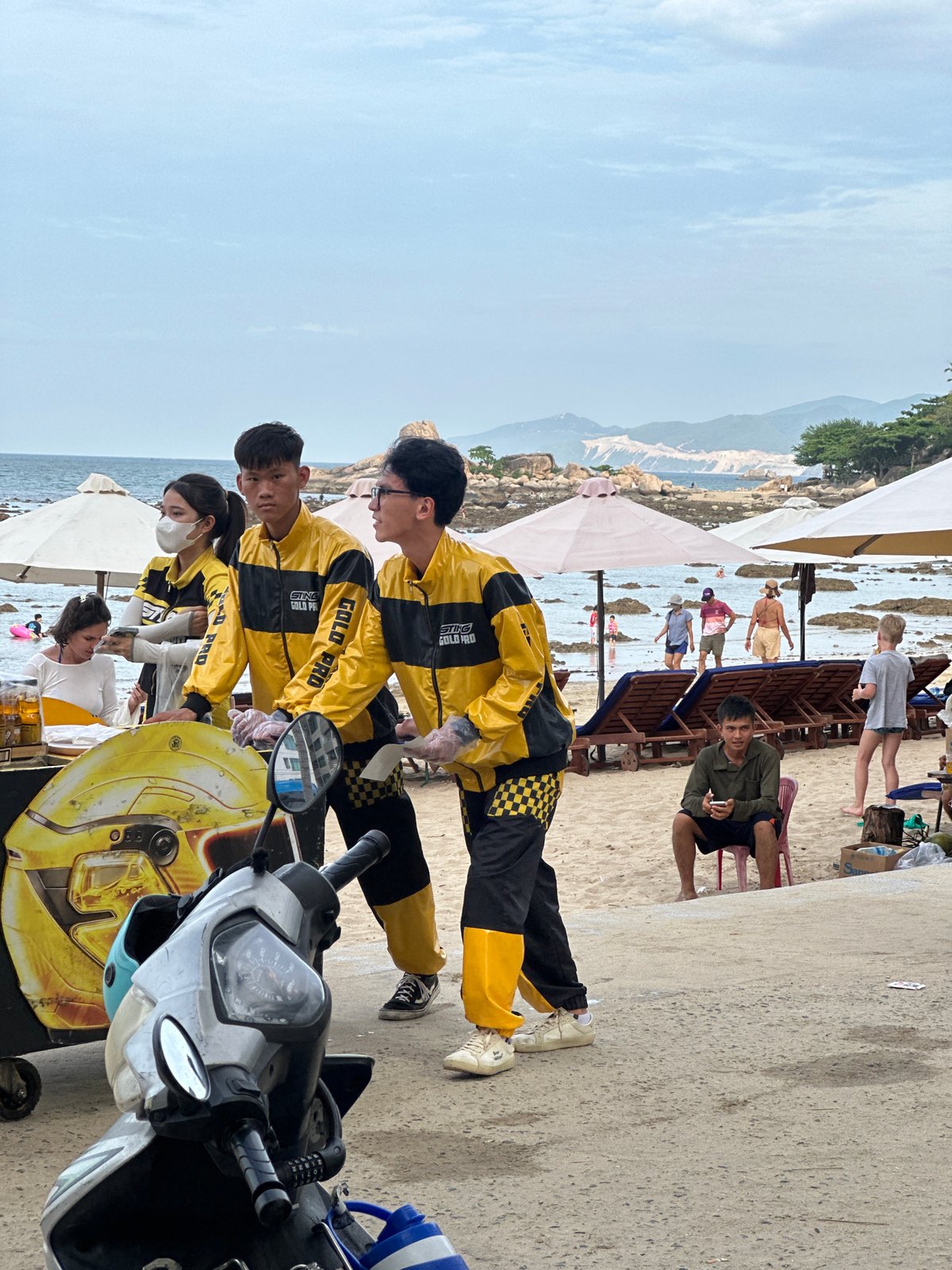 Nha Trang beachfront buzzing with vendors, swimmers, and scooters