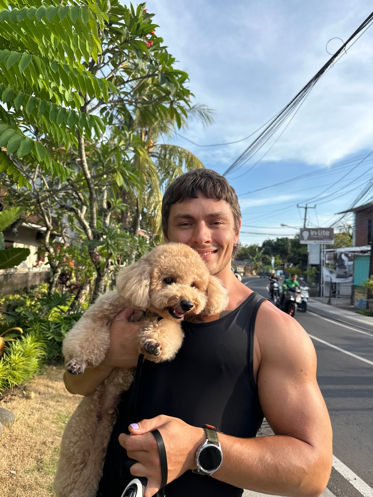 Man with poodle photographed on North Kuta street