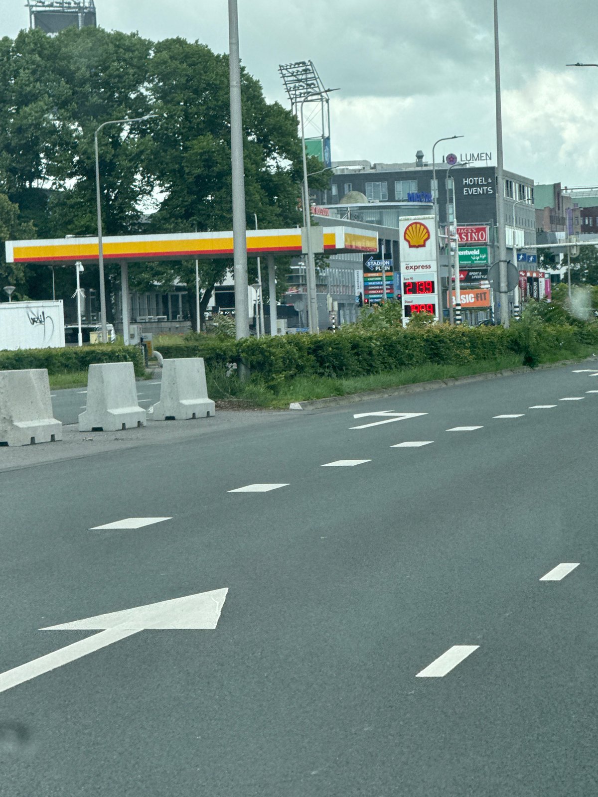Driver navigates through commercial Zwolle on cloudy morning