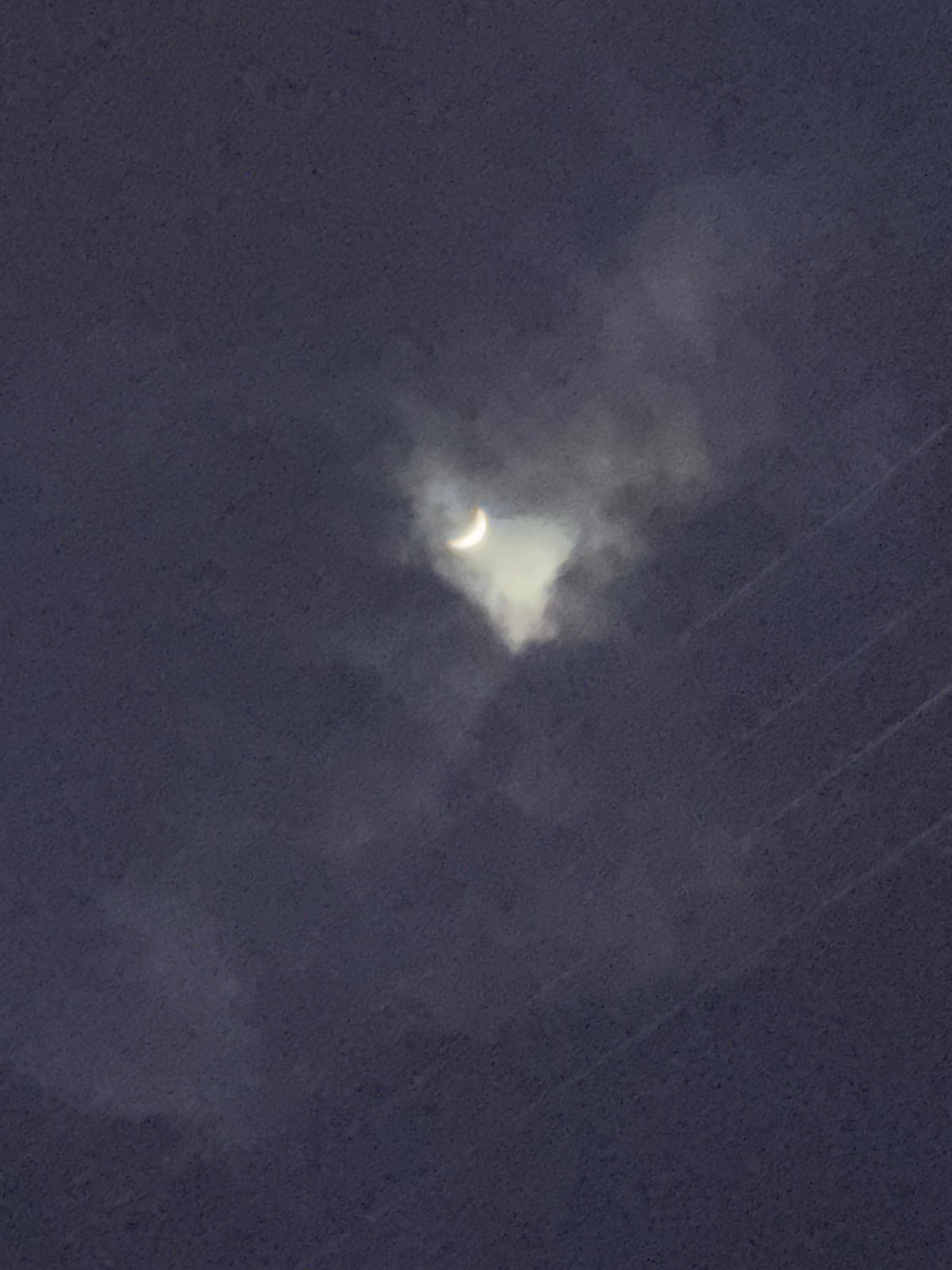 Eclipse observed through clouds in Oktyabrsky, Russia