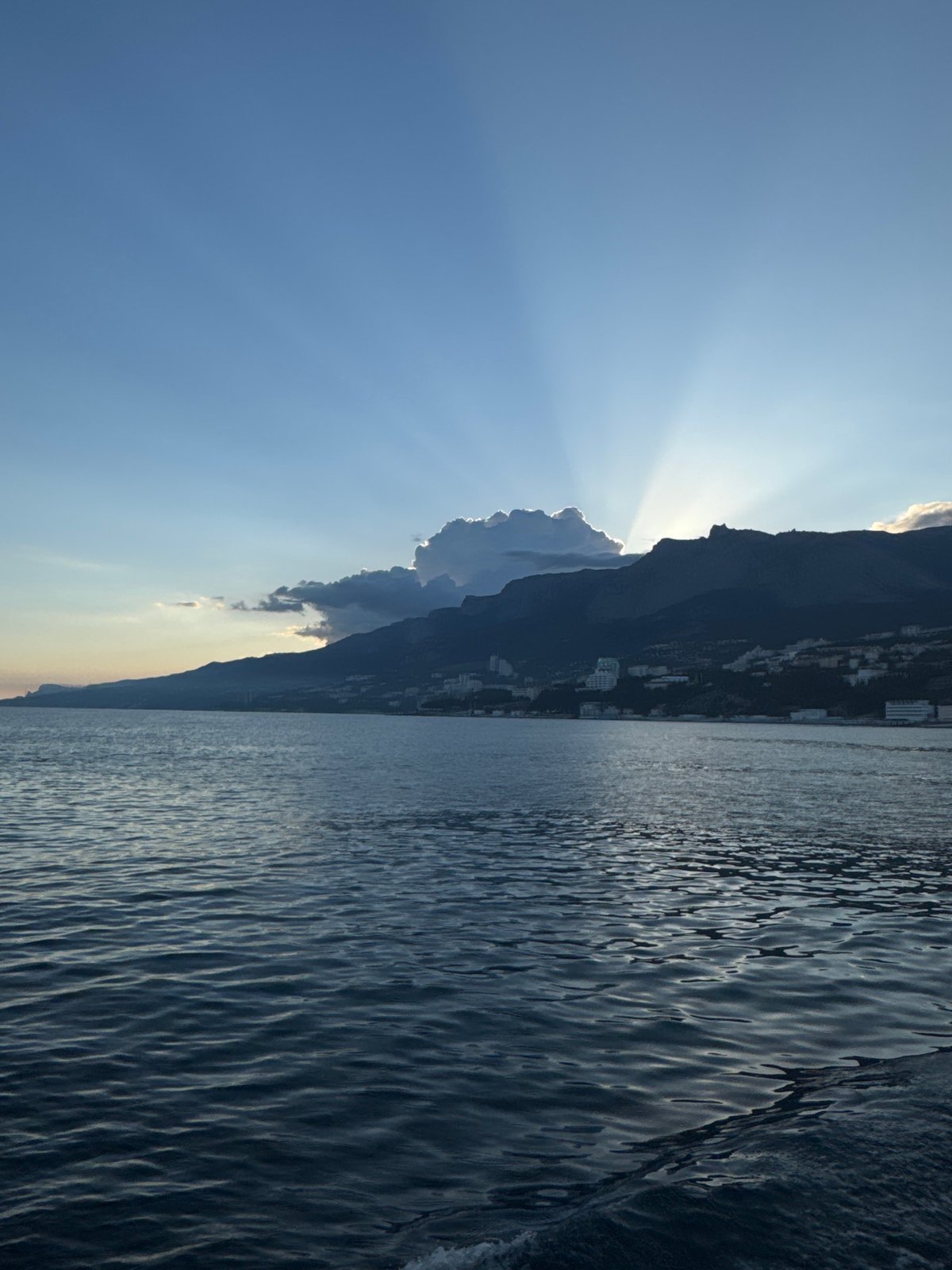 Sunlight through mountains captured in Ukrainian coastal village