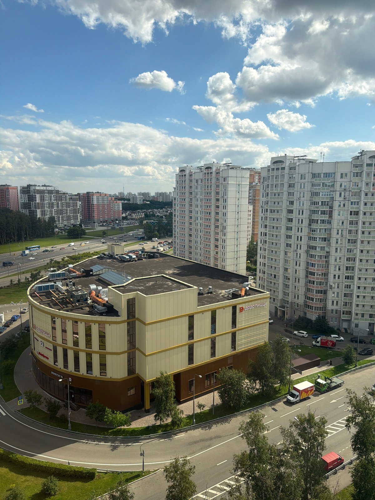 Aerial views of a curved Moscow commercial building, with a few odd ones out