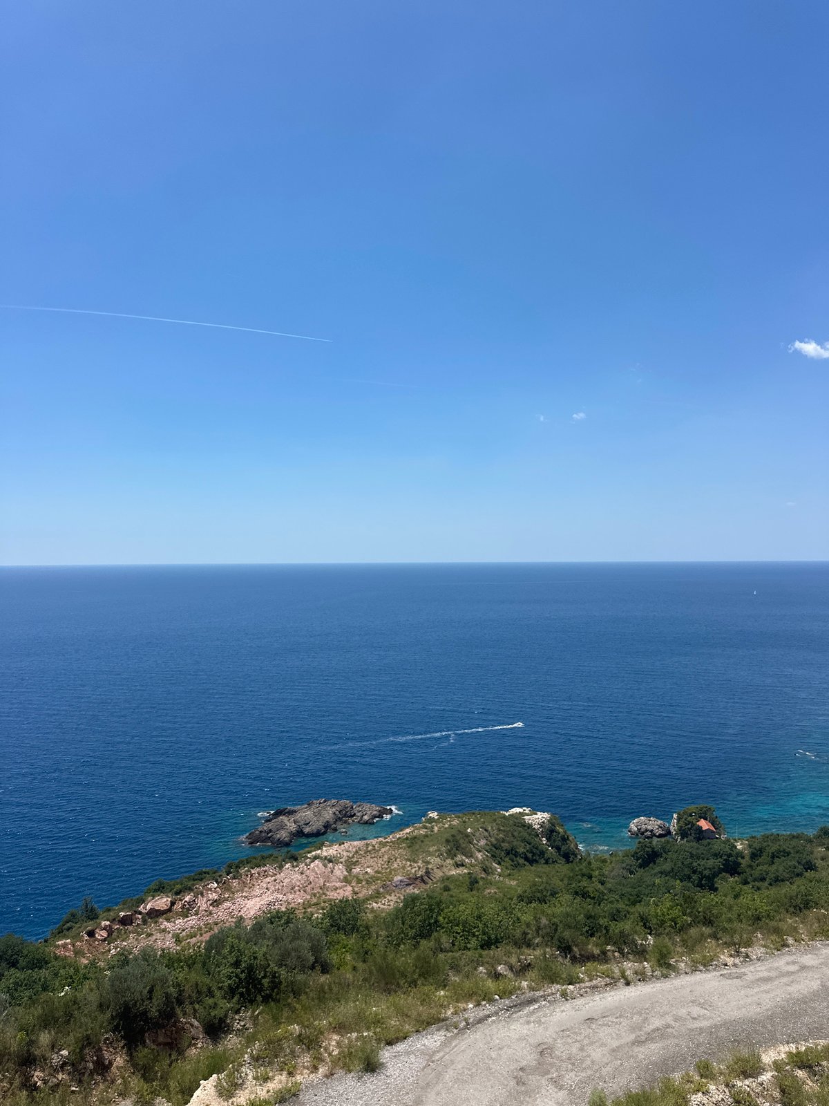 Summer day at Mirište beach, Montenegro — paddleboarding, sunbathing, coastal views