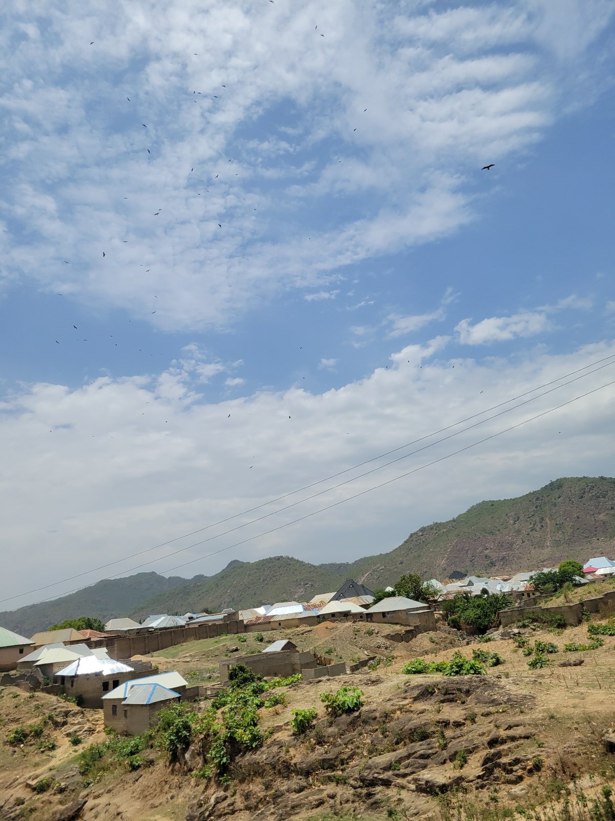 Hillside village with colorful roofs documented in Tilde, Nigeria