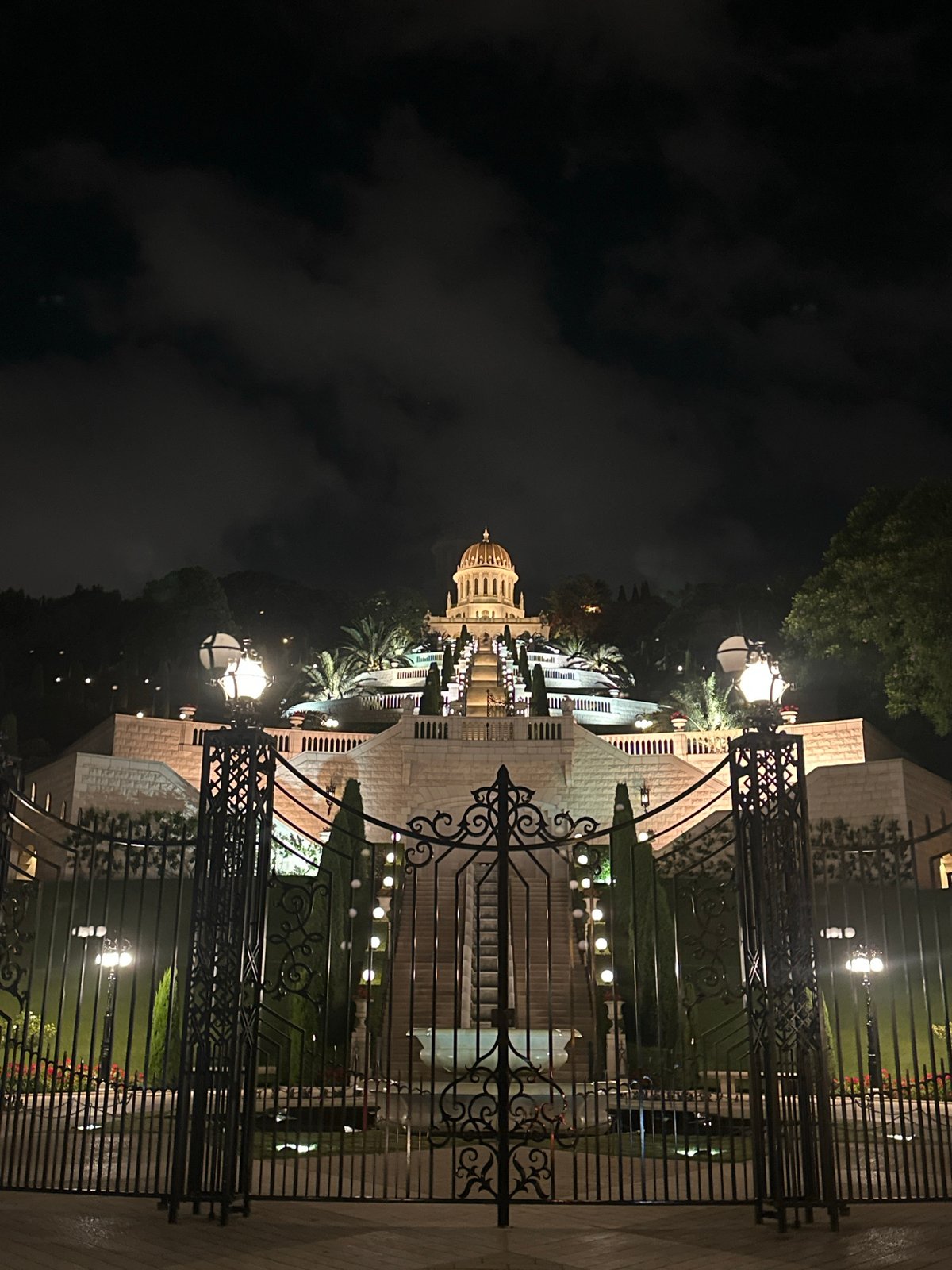 Baháʼí World Centre lit up after dark in Haifa