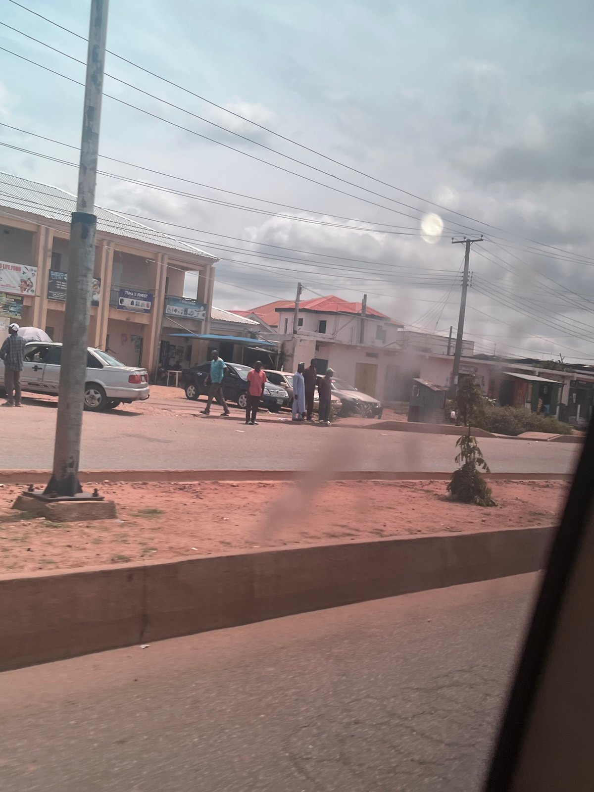 Roadside scene along a paved street in Bukuru, Nigeria