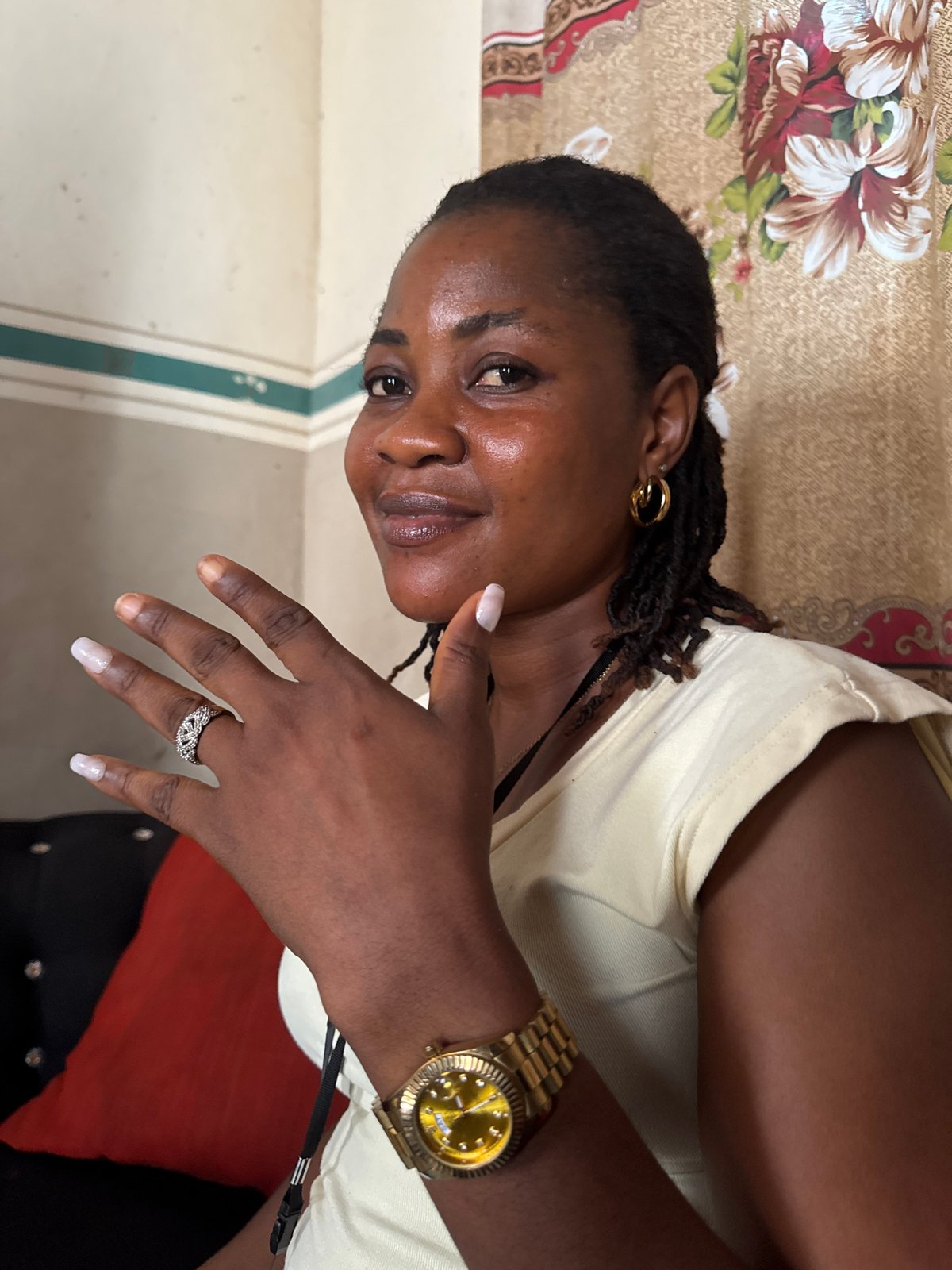Woman enjoys meal in Badagry home wearing gold jewelry