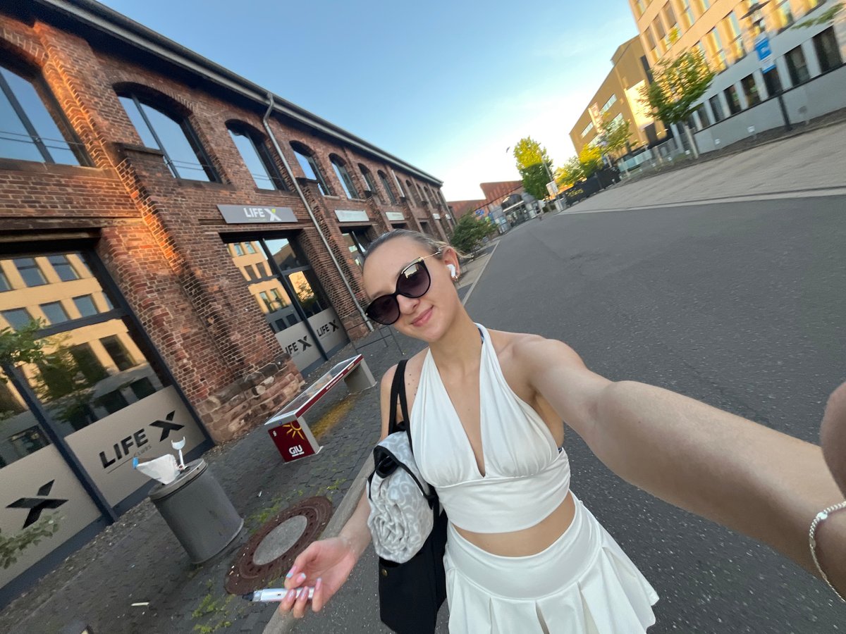 Woman in white takes selfies across Saarbrücken streets