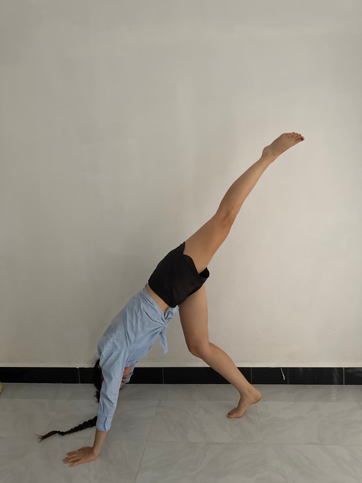 Person captured in dynamic inverted pose in Mũi Né