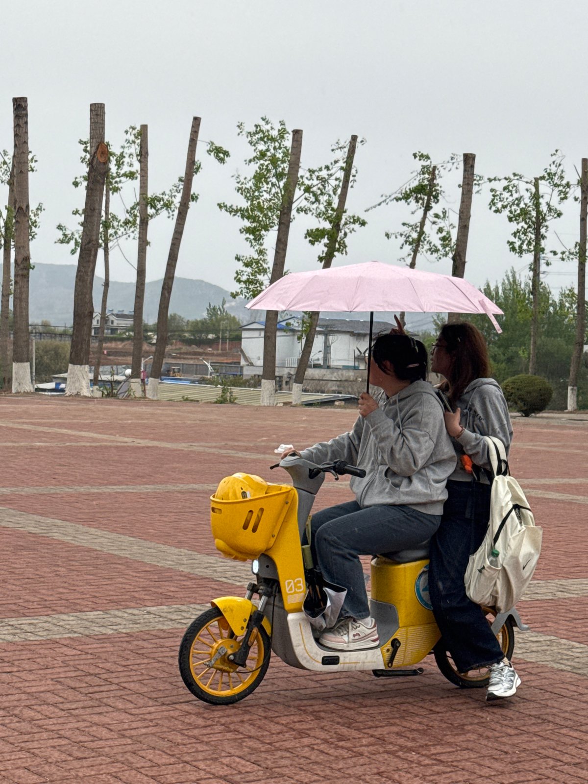 Early morning scooter rides and umbrella walks in Zhongtun
