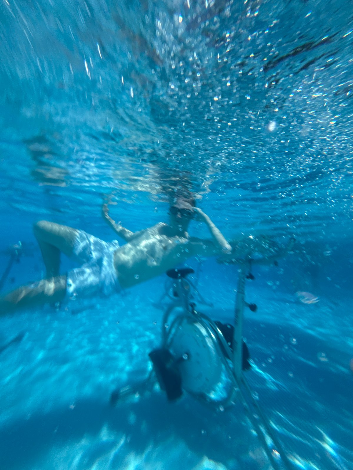 Underwater stationary bikes in use at a Manavgat pool