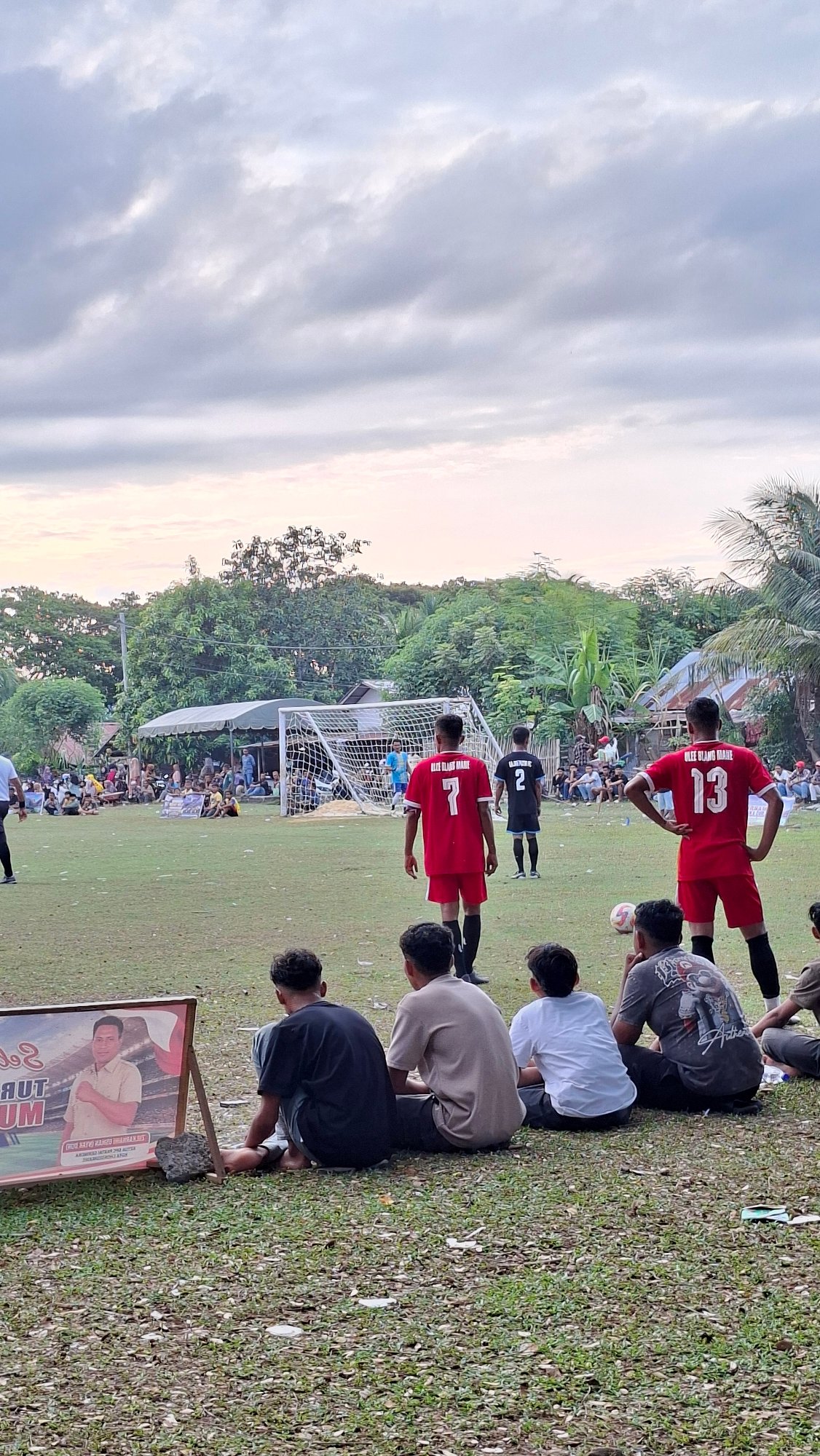 Local soccer match underway in Lhokseumawe with crowd watching