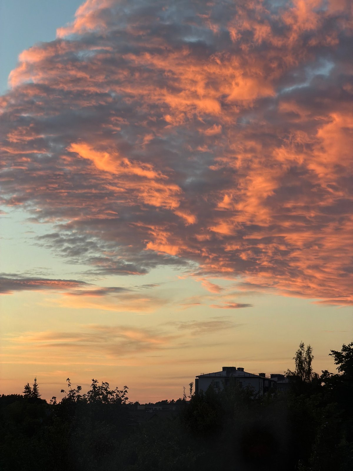 Colorful summer sunset skies over Dreiliņi, Latvia