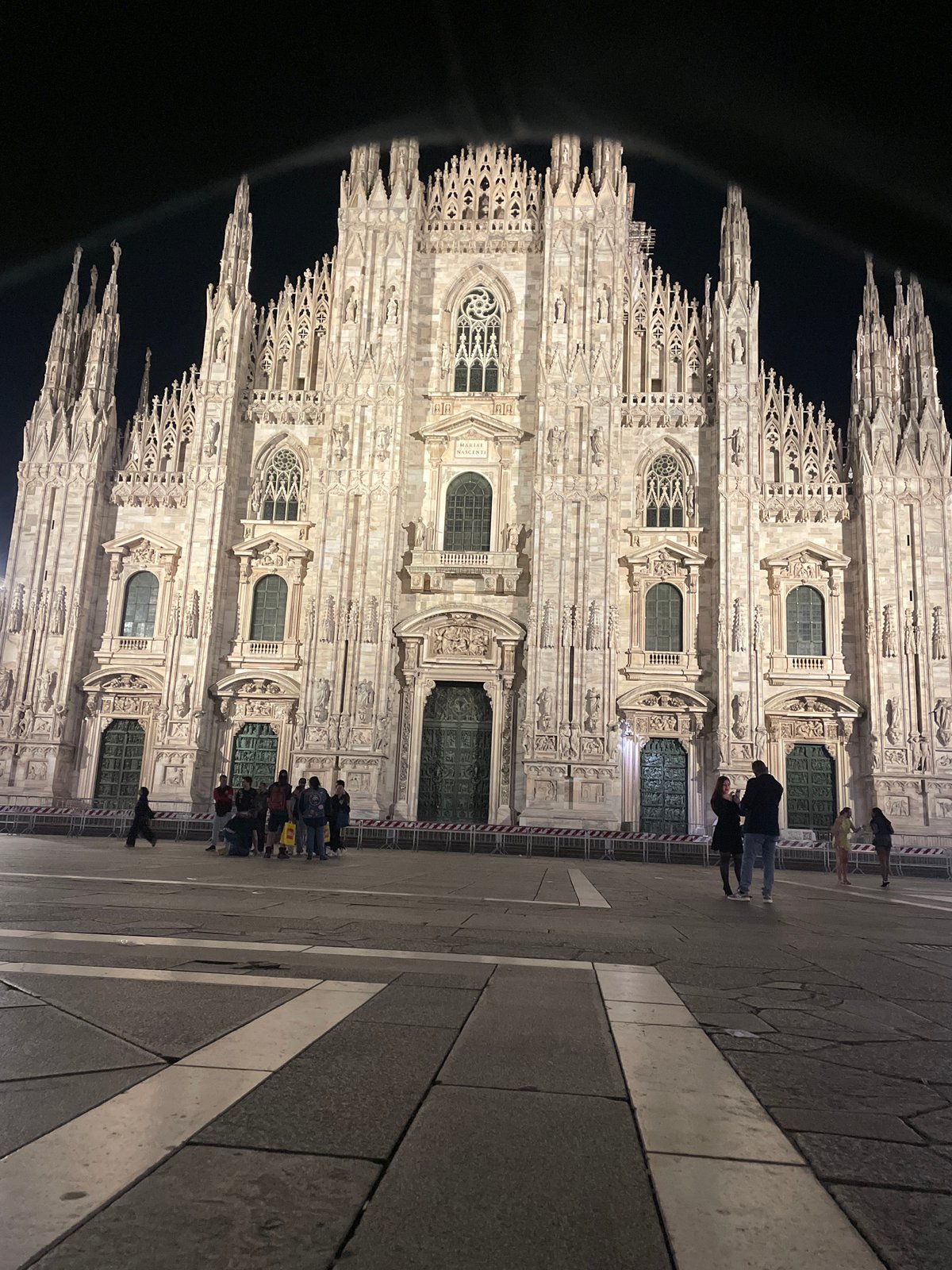 Nighttime gathering at Milan's Duomo cathedral captured by witness
