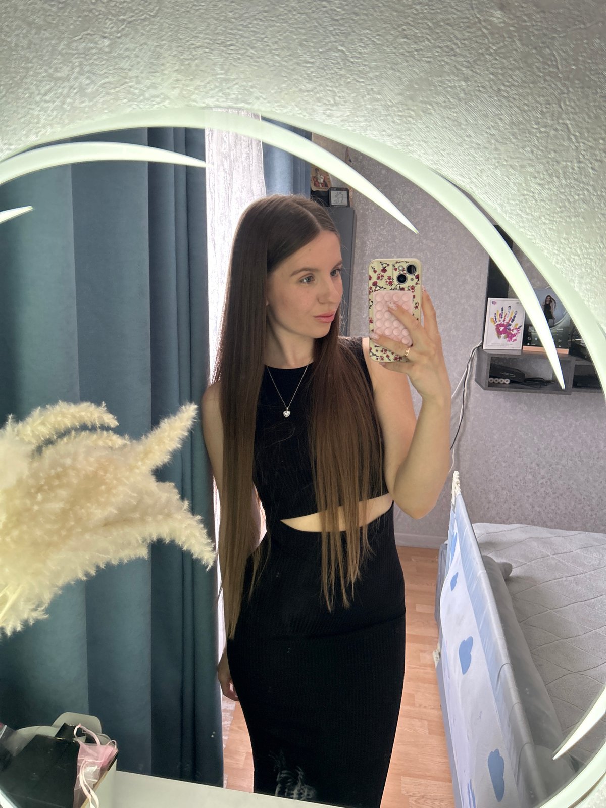 Woman photographs herself in black outfit, Klin Russia