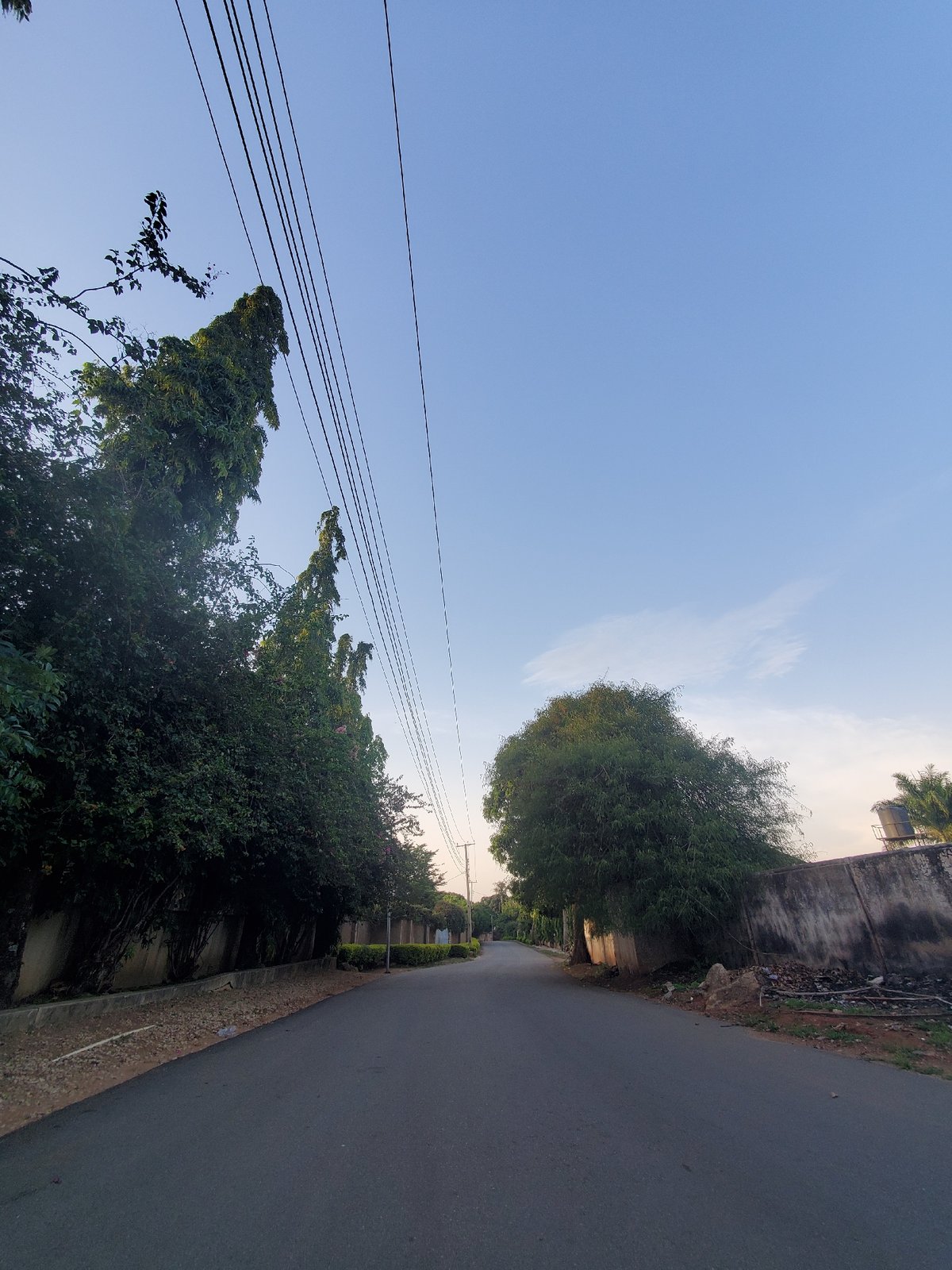 Streets and skies across a Jos neighborhood at golden hour