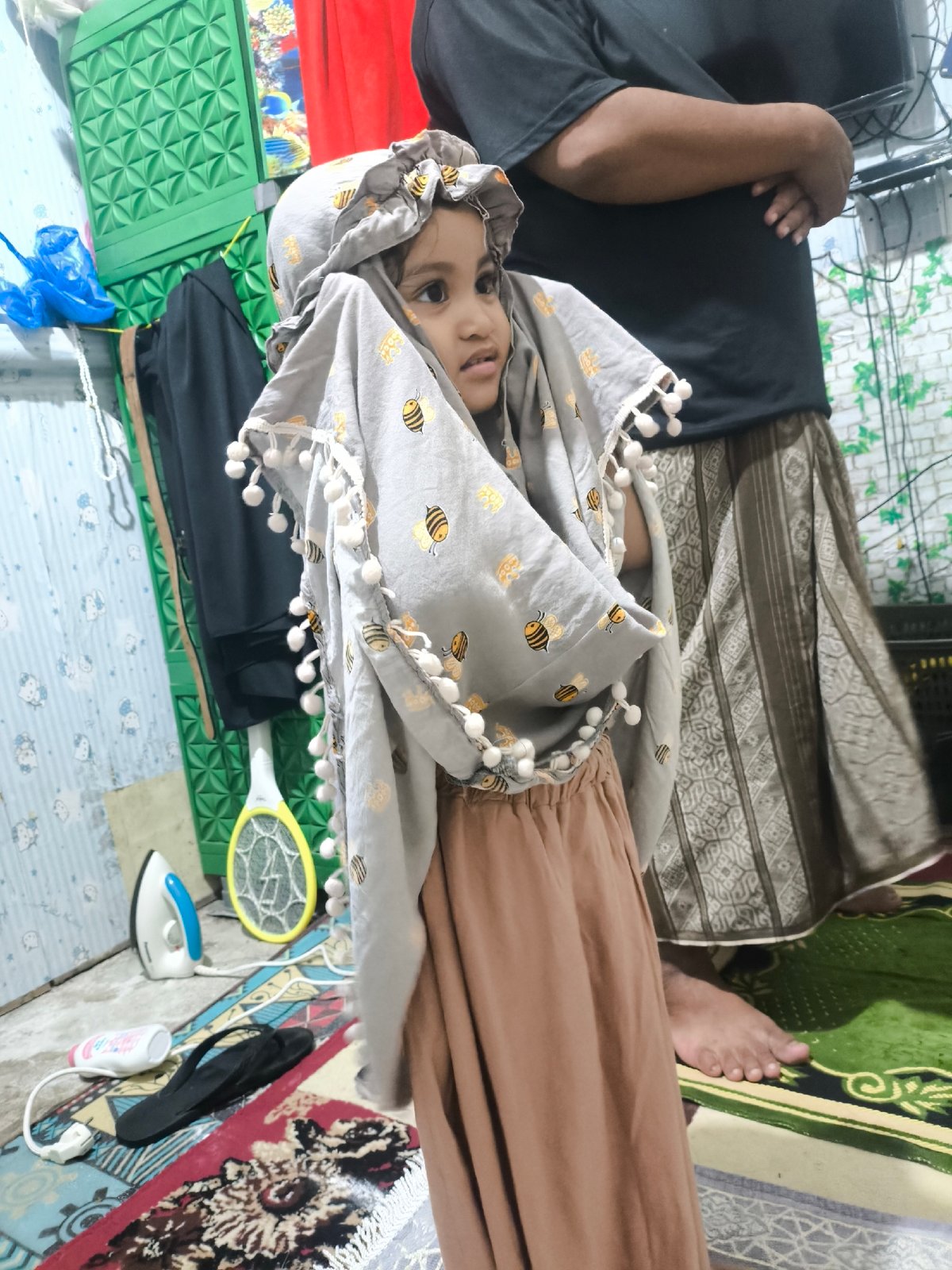 Bee-patterned hijab and pom-poms in Blangseureukuy, Indonesia