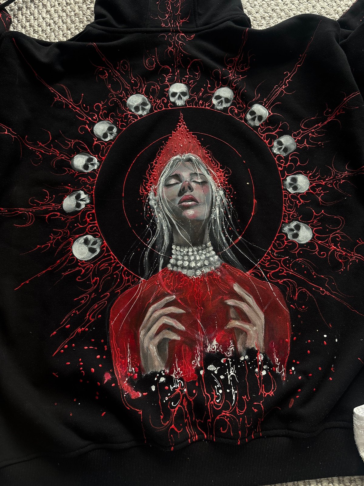 Artist documents gothic hoodie painting project in Krasnoyarsk