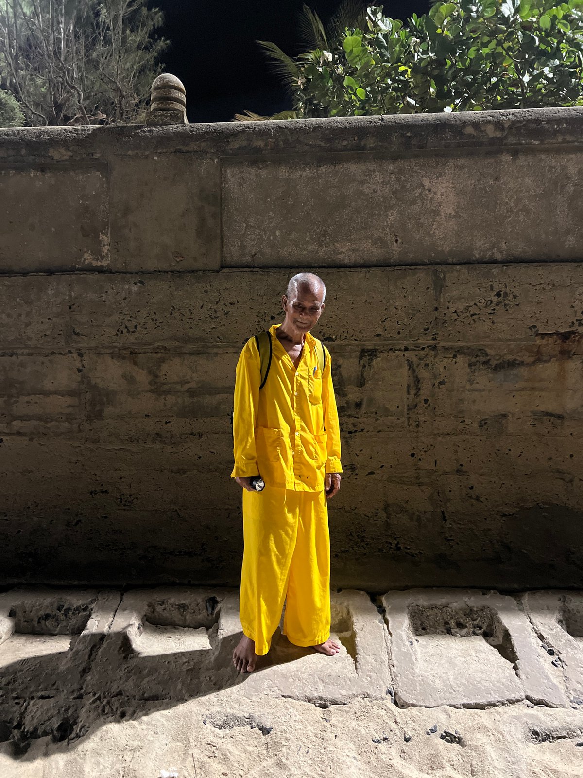 Elderly man in yellow jumpsuit photographed in Nha Trang