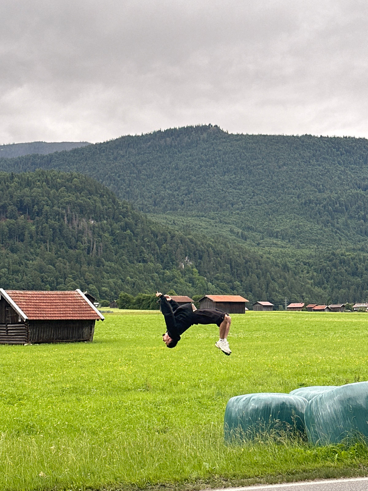 Person performs backflips in Bavarian countryside near Garmisch-Partenkirchen