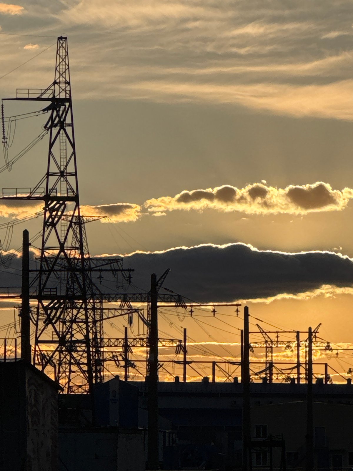 Power lines silhouetted against dramatic sky in Volzhsky, Russia
