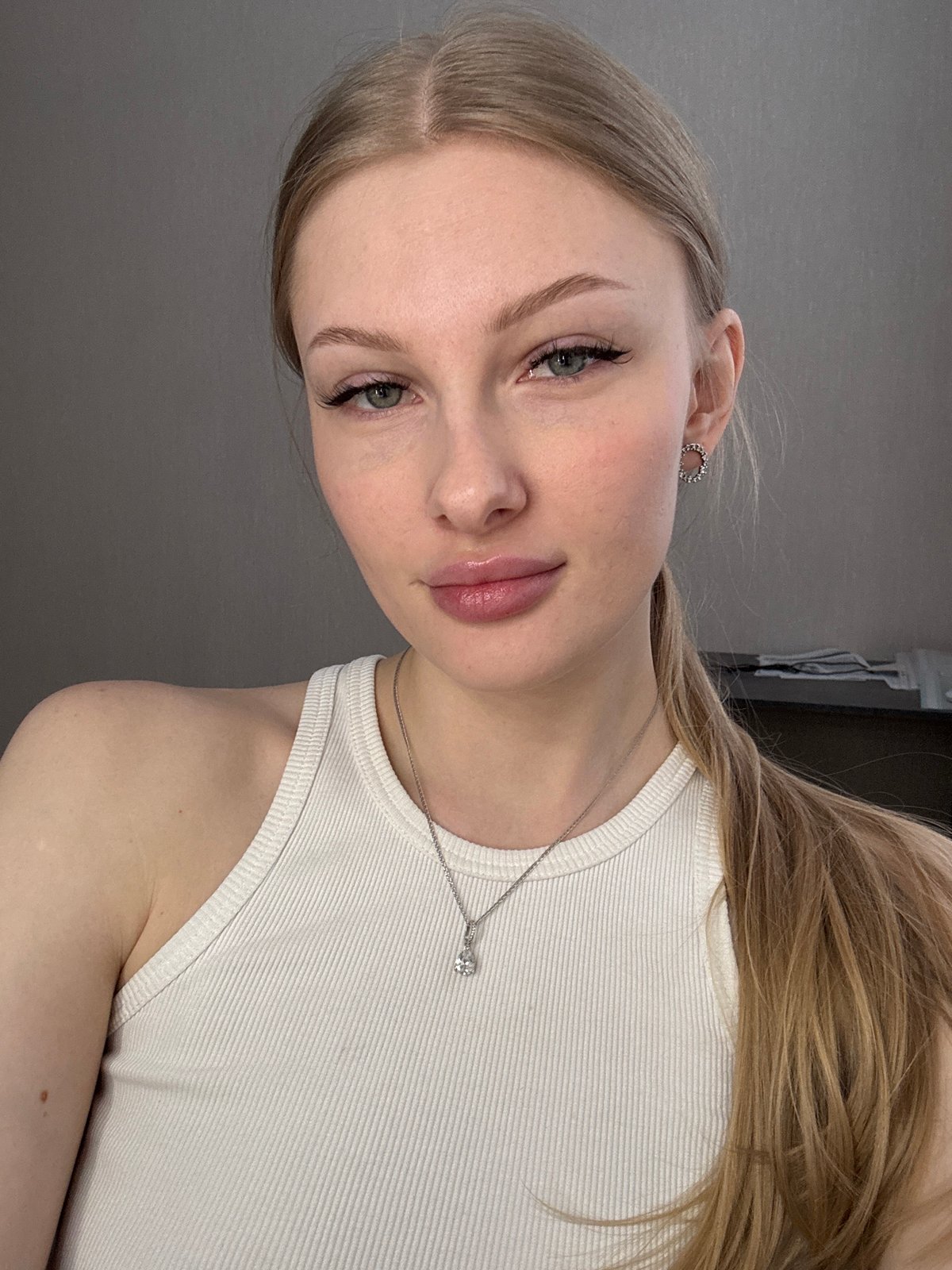 Woman applies makeup during morning routine in Perm