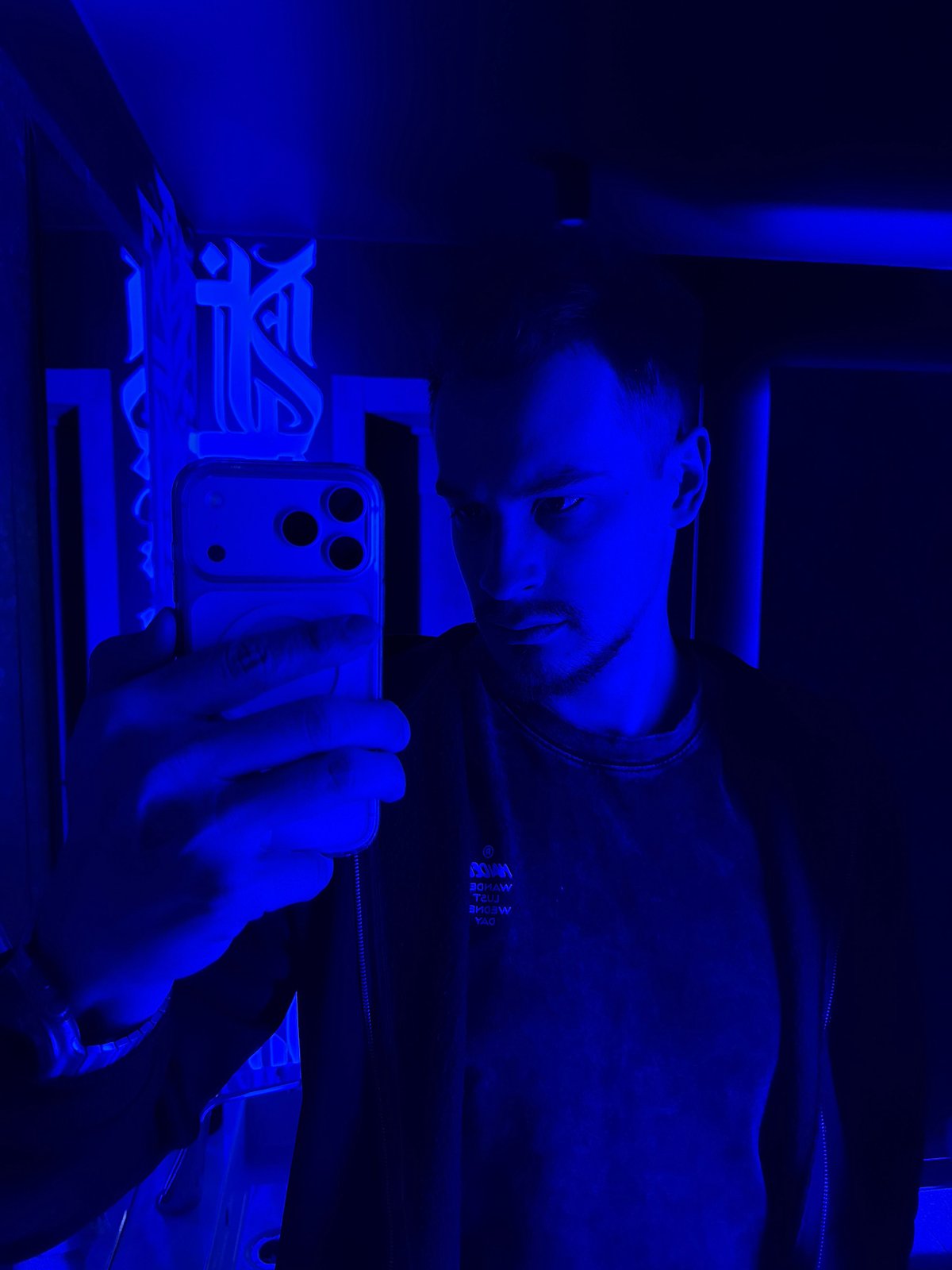 Man takes selfie in blue-lit room in Krasnoyarsk