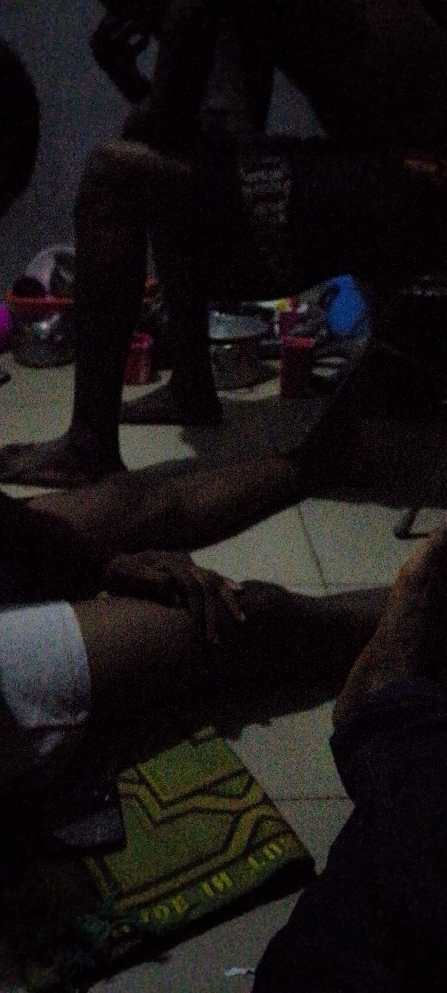 Grainy indoor scene captures multiple people in dim lighting