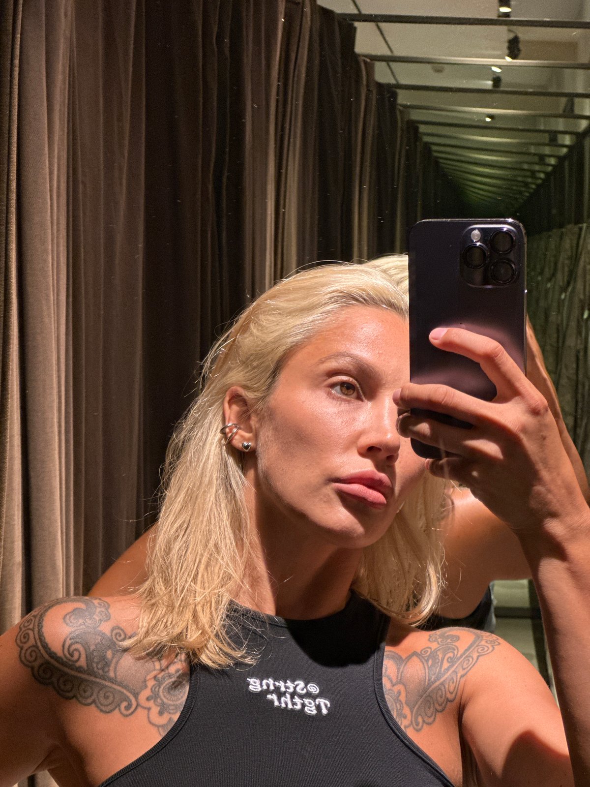 Woman Takes Multiple Selfies While Trying On Clothes in Kuta